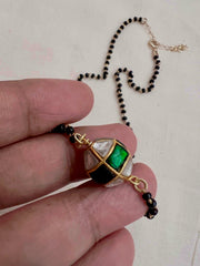 Mangalsutra style black bead chain with kundan & emerald bead pendant