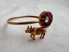 Gold polish kundan & ruby kada with cow motif