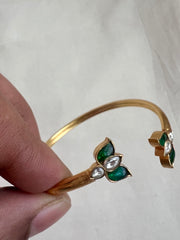 Gold polish kundan and emerald flower kada