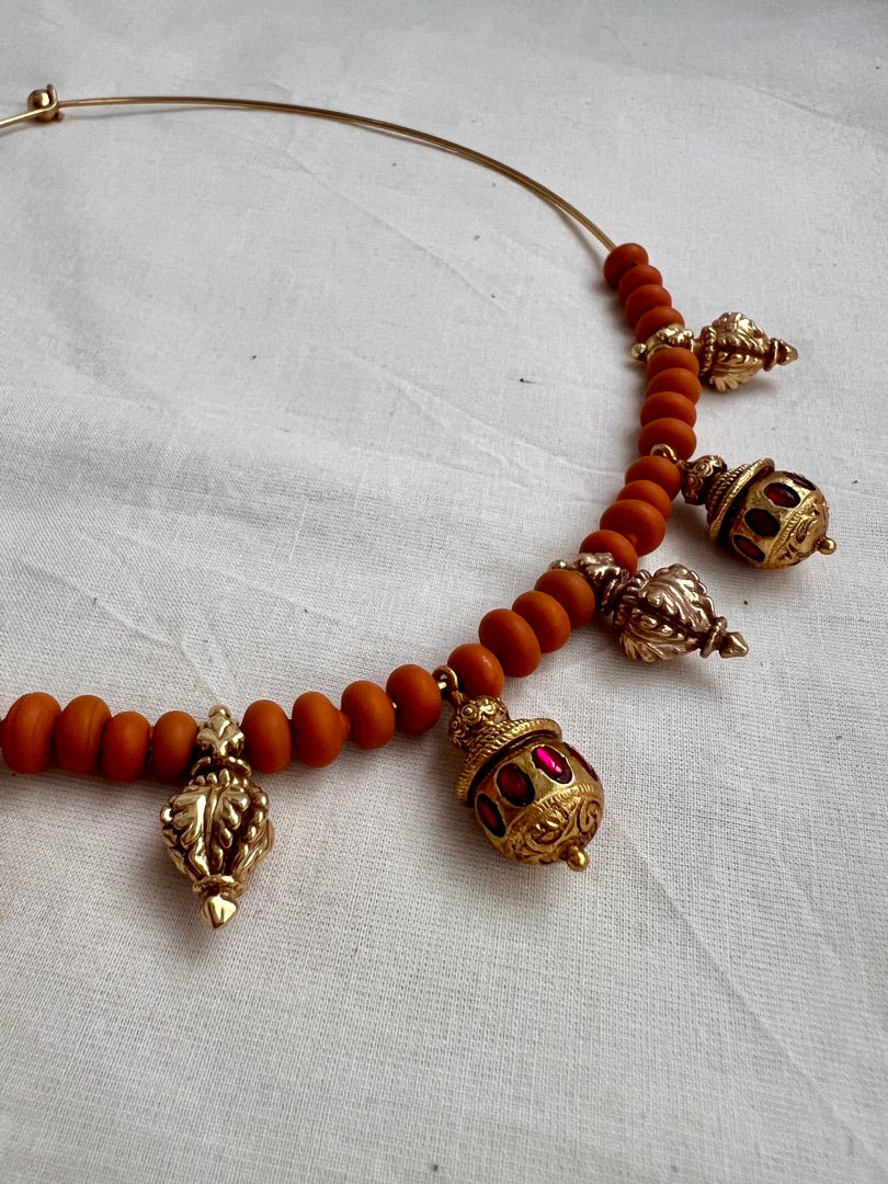Gold polish hasli with coral beads and ruby motifs