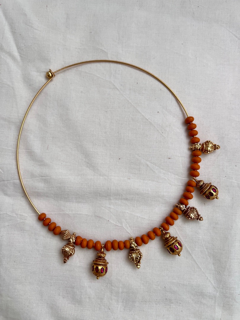 Gold polish hasli with coral beads and ruby motifs