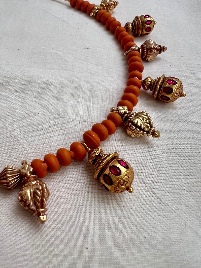 Gold polish hasli with coral beads and ruby motifs
