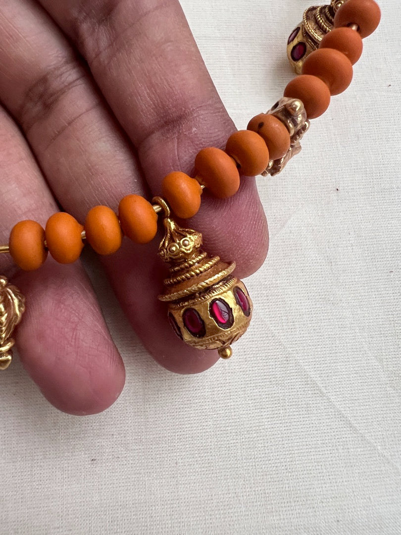 Gold polish hasli with coral beads and ruby motifs