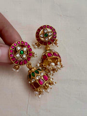 Gold polish kundan, ruby and emerald jhumkas with pearls