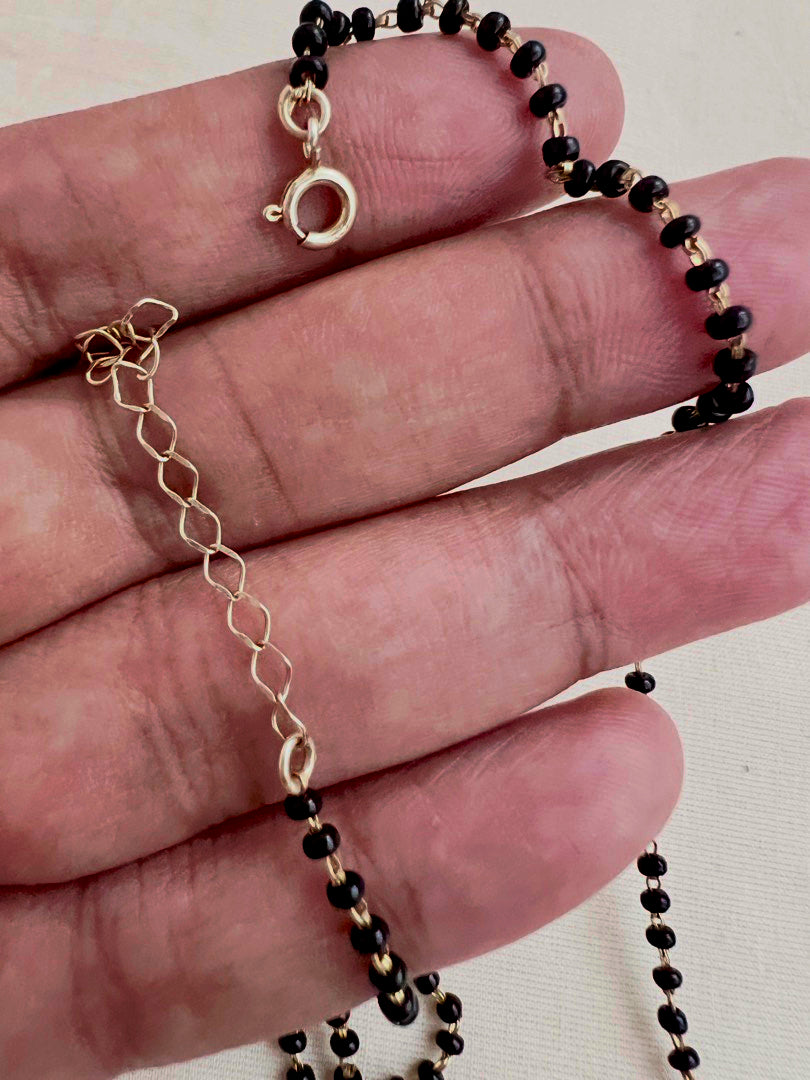 Mangalsutra style black bead chain with kundan & emerald bead pendant
