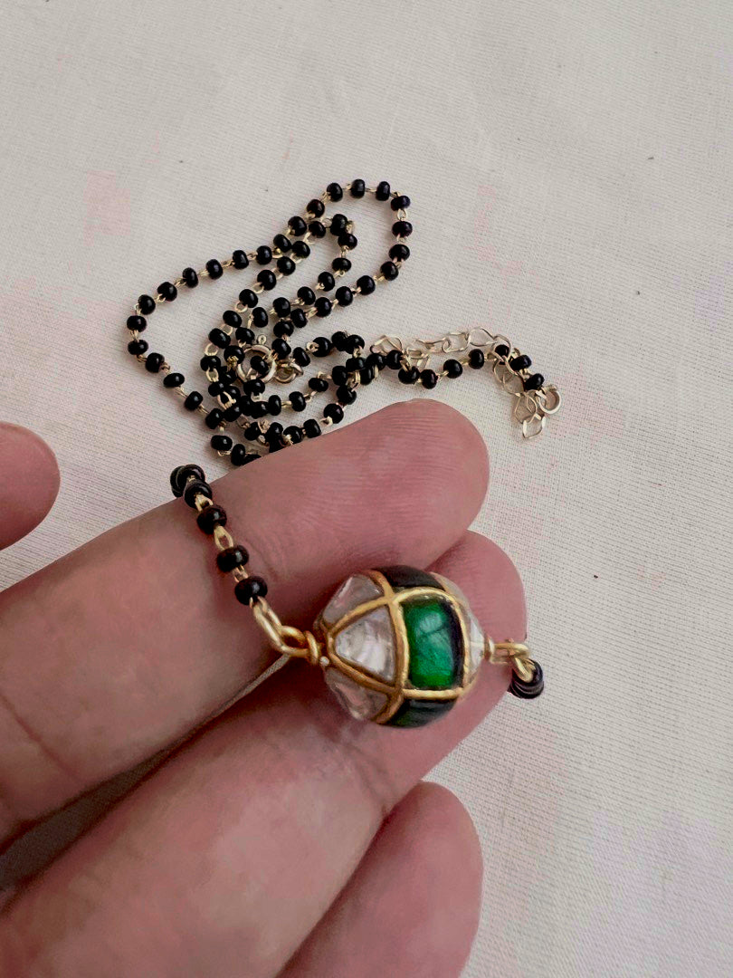 Mangalsutra style black bead chain with kundan & emerald bead pendant
